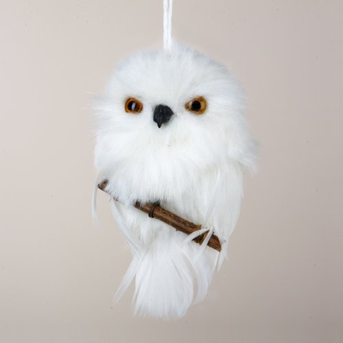 White snowy owl perched on branch ornament